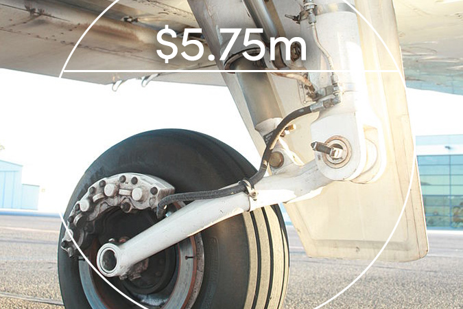 Landing wheel of airplane on tarmac with text overlaid: $5.75m