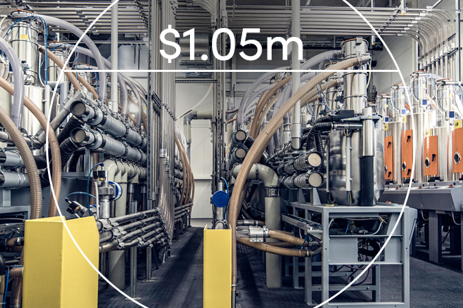 Factory machinery with text overlaid: $1.05m